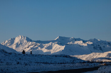 Sun and shadows on snowy mountain in Alaska