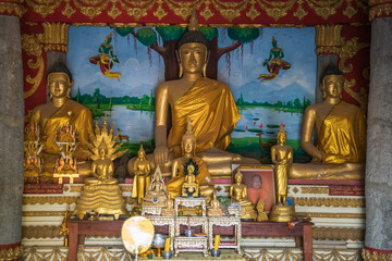 Laos, Vang Vieng, Majestic Golden Buddha Statue Gracefully Surrounded by Lush Natures Beauty Vientiane, Laos