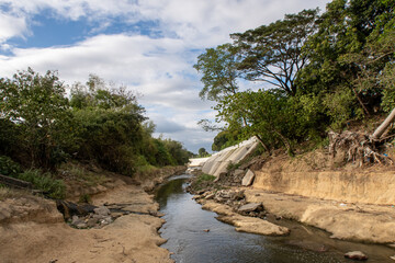 The Ylang Ylang River in Cavite, Philippines, is at a low water level. The river banks are built so it can swallow enormous amounts of water to prevent flooding in the area