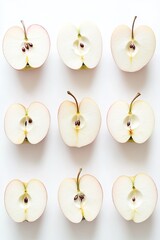 Sliced apples arranged symmetrically, showcasing seeds and textu