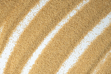 Raw organic amaranth grains on a white background, top view