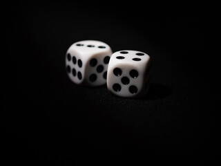 Black and white dice on black background