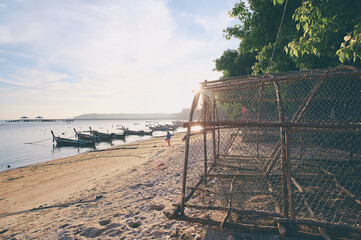 Serene Beach Scene With Fishing Boats and Rustic Traps at Sunrise