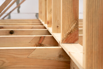 Making a wooden roof. Close-up wooden roof trusses in a frame structure. Steel beam connections....