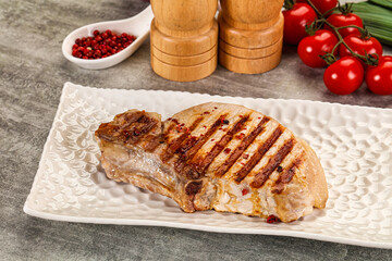 Grilled pork loin steak with bone