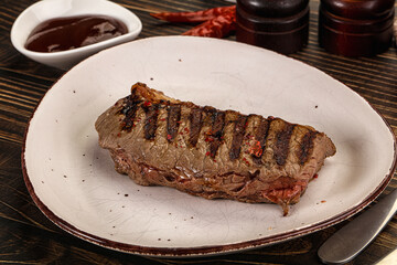 Grilled beef striploin steak with sauce