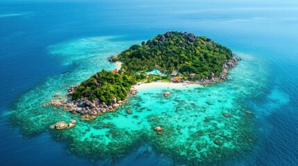 Fototapeta premium A bird's-eye view of a tropical island surrounded by crystal-clear waters and coral reefs