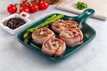Tasty grilled pork medallion with bacon