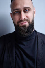 Studio portrait of young handsome man with beard.