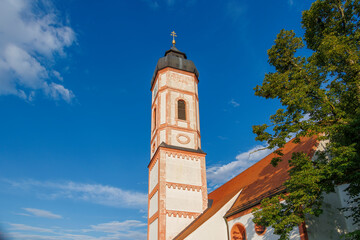 church of saint Sebastien under a blue sky with village cemetery and the thousand-year-old ediga lime tree in germany, Puch, 20.7.2024 © were