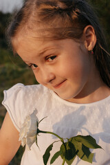 The girl smiles. The child plays with facial expressions.