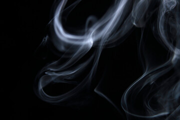 Fototapeta premium Ethereal Smoke Patterns on Black Background for Creative Use