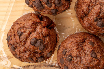 Chocolate muffins with coffee and kitchen utensils, close-up, top view.