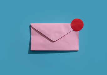 Pink envelope with notification red dot on a blue background..