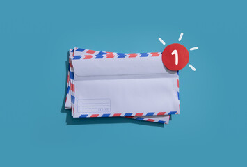 White envelope with notification red dot on a blue background..