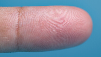 closeup shot of a human finger skin on a bue background