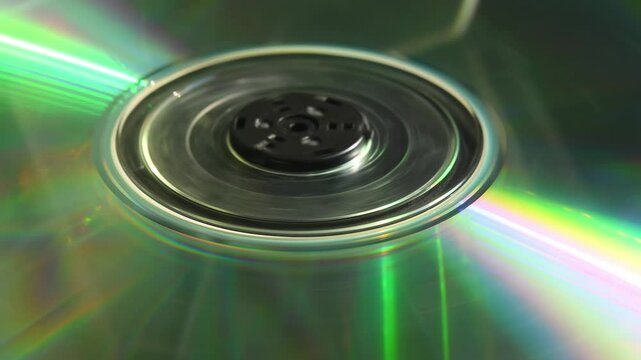 CD disc spinning and stopping under light, reflecting rainbow colors evoking nostalgic 90s tech atmosphere in 4K