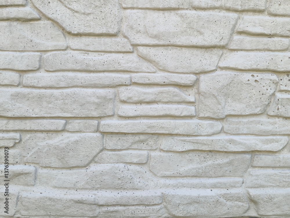 Poster close-up of a textured white stone wall, highlighting the detailed patterns and variations. ideal fo