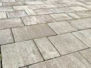 Close-up view of textured paving stones providing a durable outdoor surface in a modern urban...
