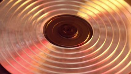 Shimmering mosaic disk spins hypnotically in warm light, evoking nostalgic 90s vibe and analog-era aesthetics in cinematic 4K