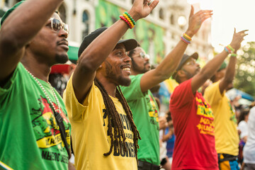 rastafari men, reggae dancers performing at a street festival