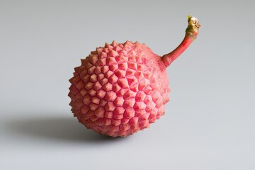 A close up shot of a single red lychee fruit