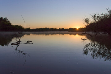 Dawn scene, warm sunlight reflects on the water surface early in the morning