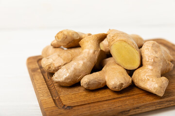 Fresh ginger on wooden background. Dry ginger. Sliced ​​ginger with honey and lemon. Ginger root. Traditional alternative medicine, healing tea for immunity. Seasoning and spices concept. Copy space.