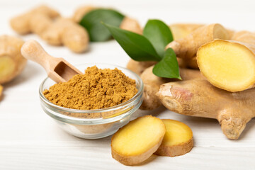 Fresh ginger on wooden background. Dry ginger. Sliced ​​ginger with honey and lemon. Ginger...