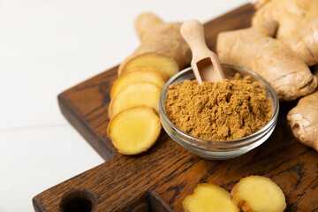 Fresh ginger on wooden background. Dry ginger. Sliced ​​ginger with honey and lemon. Ginger...