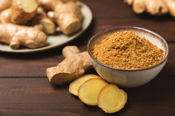 Fresh ginger on wooden background. Dry ginger. Sliced ​​ginger with honey and lemon. Ginger...