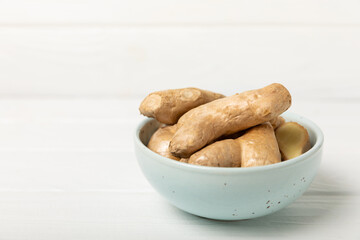 Fresh ginger on wooden background. Dry ginger. Sliced ​​ginger with honey and lemon. Ginger root. Traditional alternative medicine, healing tea for immunity. Seasoning and spices concept. Copy space.