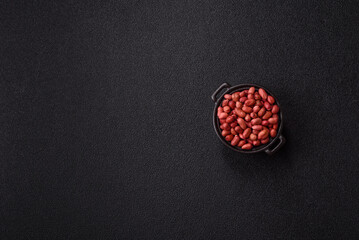 Peanuts or peeled graundnut in a bowl on a dark concrete background