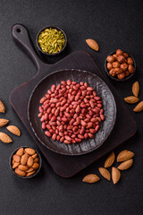 Peanuts or peeled graundnut in a bowl on a dark concrete background