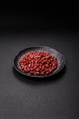 Peanuts or peeled graundnut in a bowl on a dark concrete background