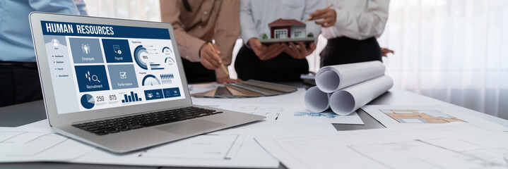 Human resources management software on computer screen helping human resources employee to manage...