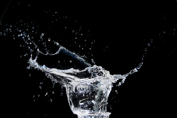 Dynamic Splash of Water Captured in Mid-Air Against a Black Background Highlighting Motion and Fluidity