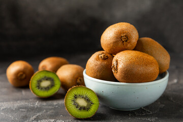 Kiwi on wooden background. Whole fruit and slices pieces of green kiwi on table. fresh ripe juicy...