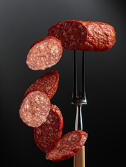 Sliced chorizo on a fork.