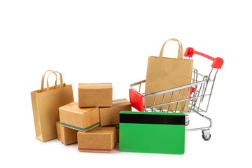 Online shopping concept.Cardboard box and shopping bags in a trolley isolated on white background....