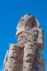 The Colossus of Memnon, one of two massive stone statues of the Pharaoh Amenhotep III in...