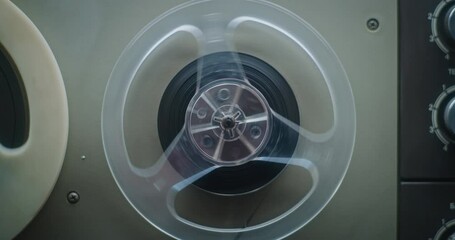 Retro Audio Cassette Tape Playing 90s Mixtapes Sound, Reels Spinning. Playback of Old Music Collection Using Hi-Fi Vintage Sound System with Nostalgic Atmosphere. Reel Tape Recorder. Macro Close Up.
