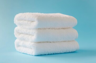 Stacked White Fluffy Towels on Blue Background Fresh and Clean
