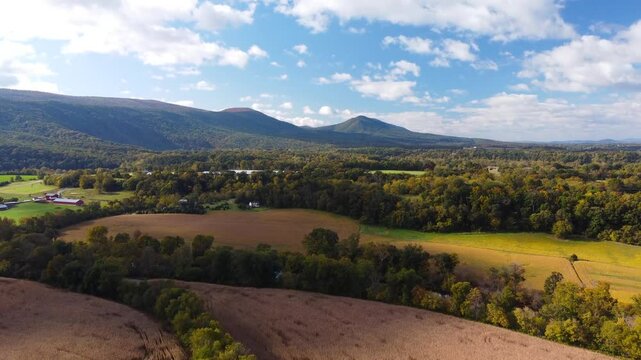 Rural Shenandoah Valley Virginia farmland surrounded by the Shenandoah Mountains during autumn. 4k Aerial View.