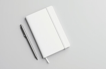White notebook and silver pen on subtle gray background, minimalist design