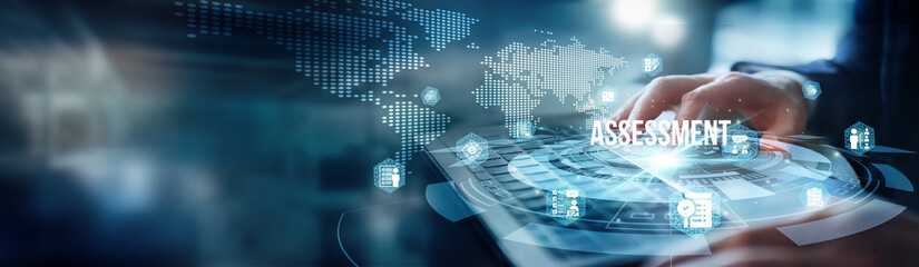 A man using a laptop analyzes data for assessment. He examines performance metrics trends and...