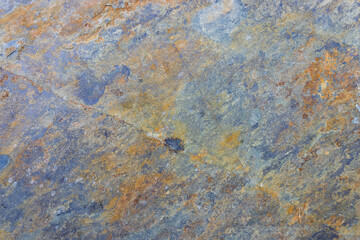 Natural multicolor stone texture background with weathered surface