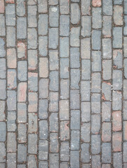 Obraz premium Old Brick Stone Pavement with Weathered and Uneven Surface Texture