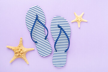 Striped blue flip flops on color background, top view