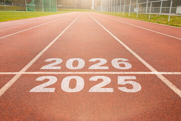 Start of new year. Changes of year 2025, 2026, 2027 on Running track. Concept of new ideas starting in new year, planning along with setting objectives to set KPI goals for success in life.